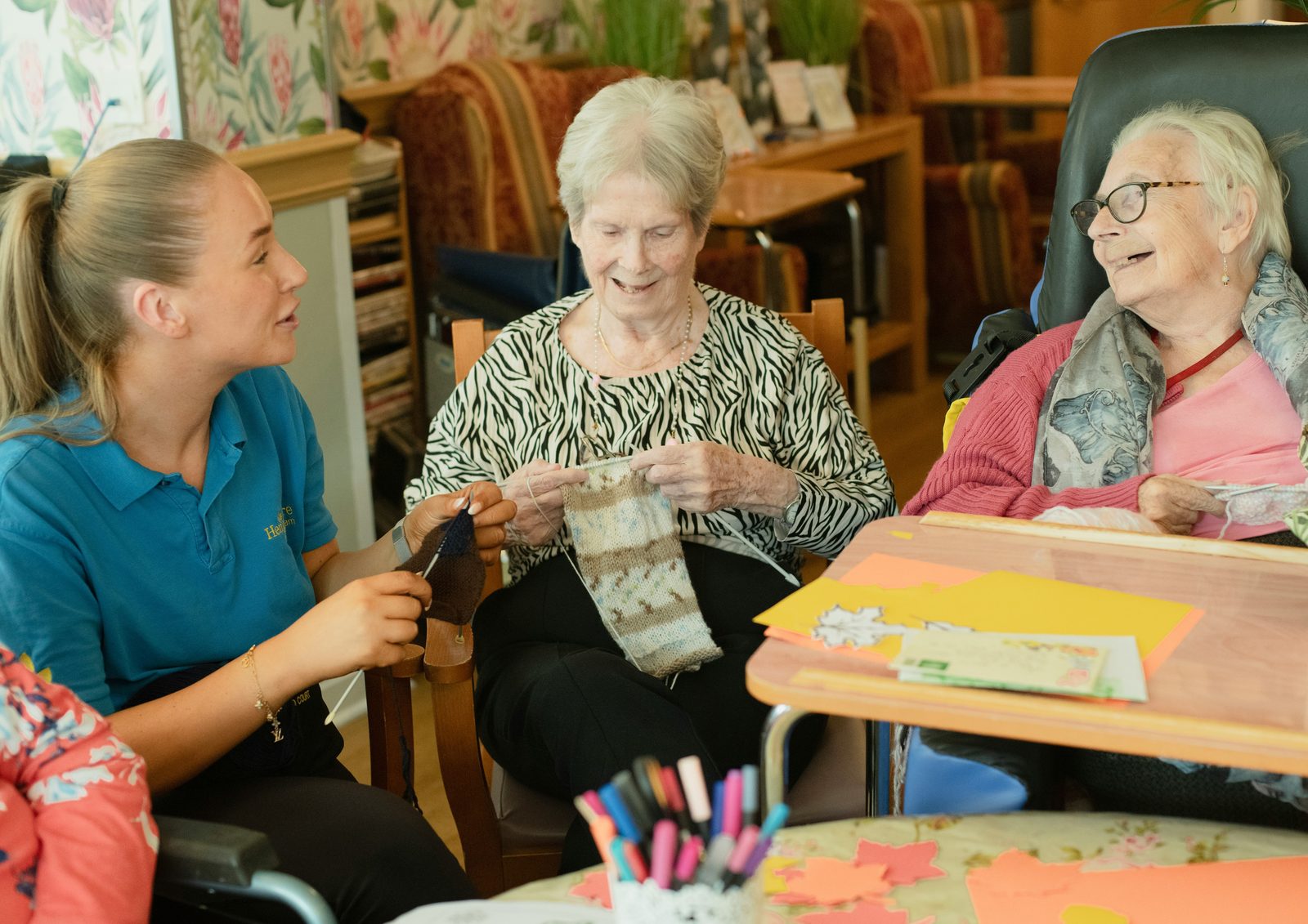 Older adults and a caregiver around a table