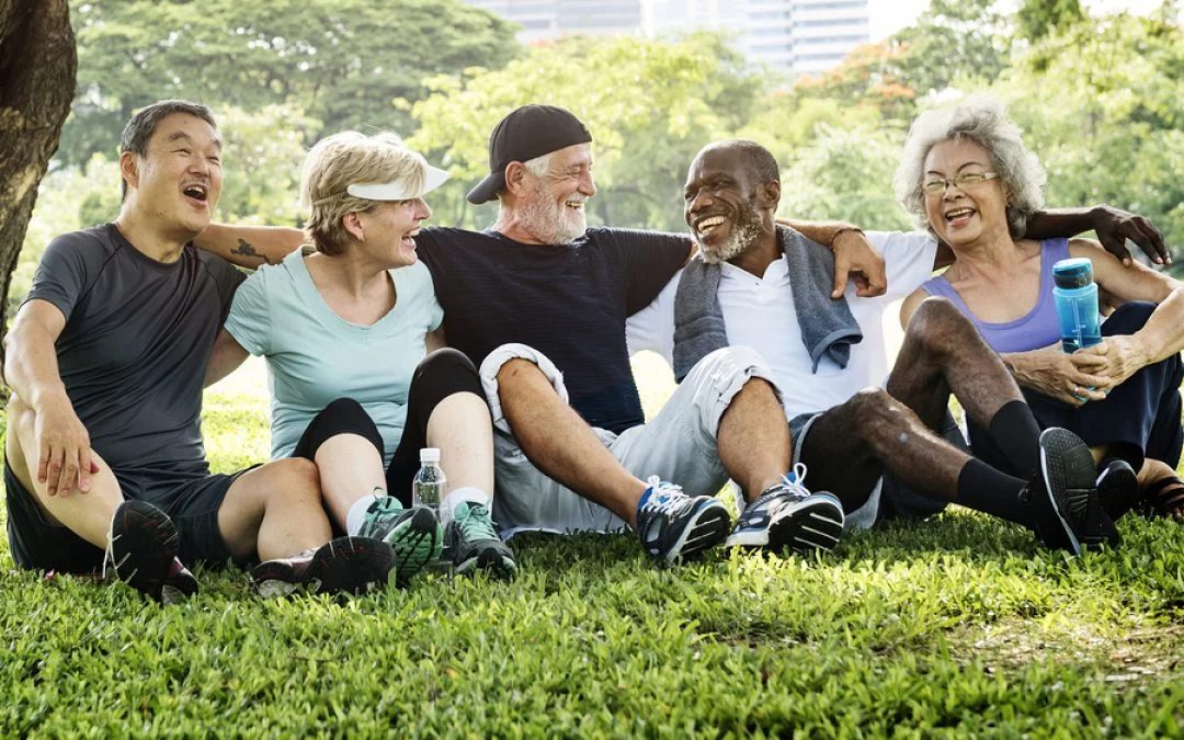 A group of older adults exercising together outdoors