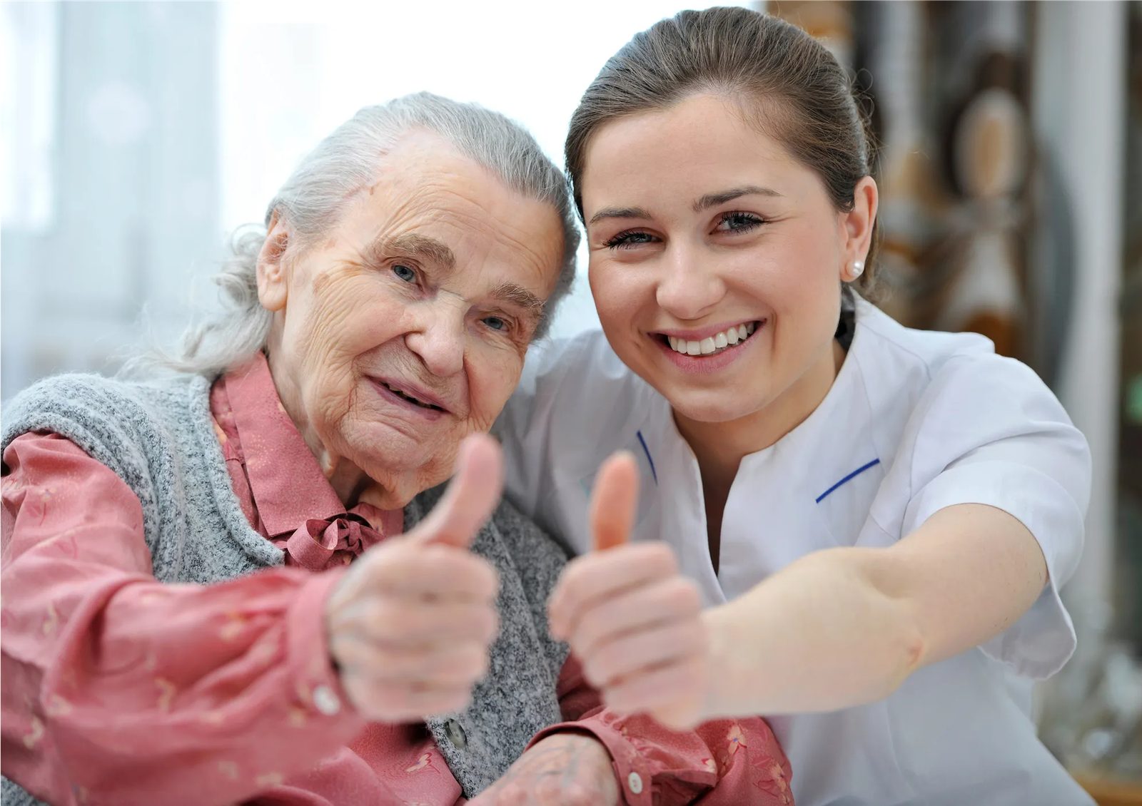 A resident and a caregiver sharing a laugh